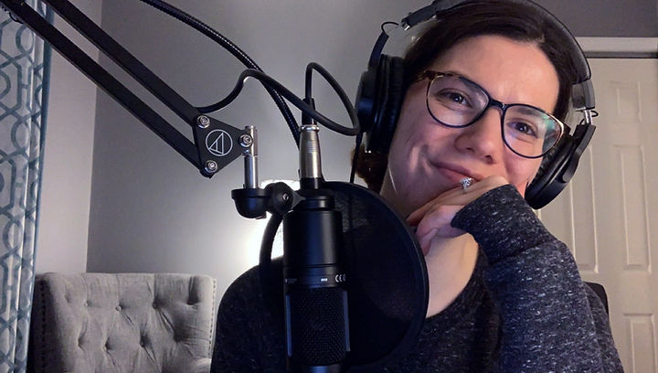 A picture of the author with her podcast headphones one
